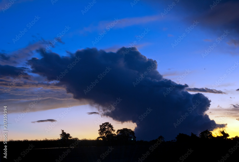  Dramatic sunset in rural area of ​​Guatemala, silhouettes of trees and outdoor space, impressive cloud in the sky and play of light.