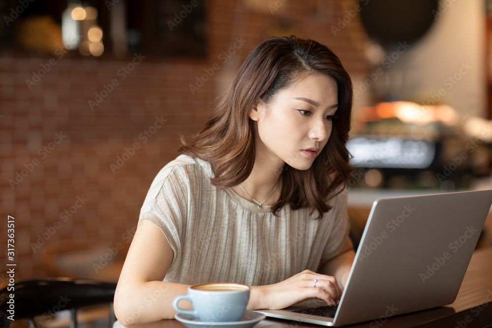 Elegant woman using laptop in cafe Elegant woman using laptop in cafe