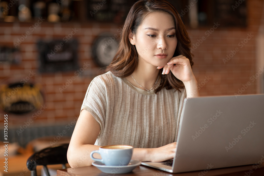 Elegant woman using laptop in cafe Elegant woman using laptop in cafe