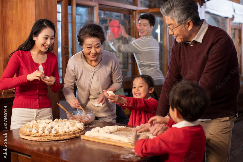 Happy family making dumplings Happy family making dumplings