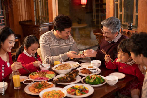 Happy family eating dinner for Chinese New Year