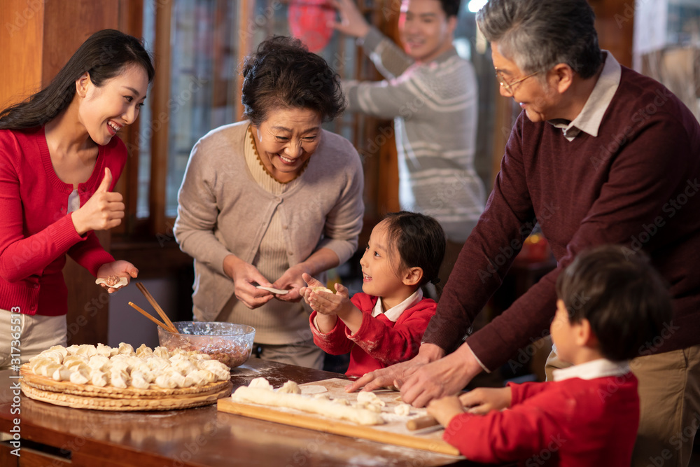 Happy family making dumplings Happy family making dumplings