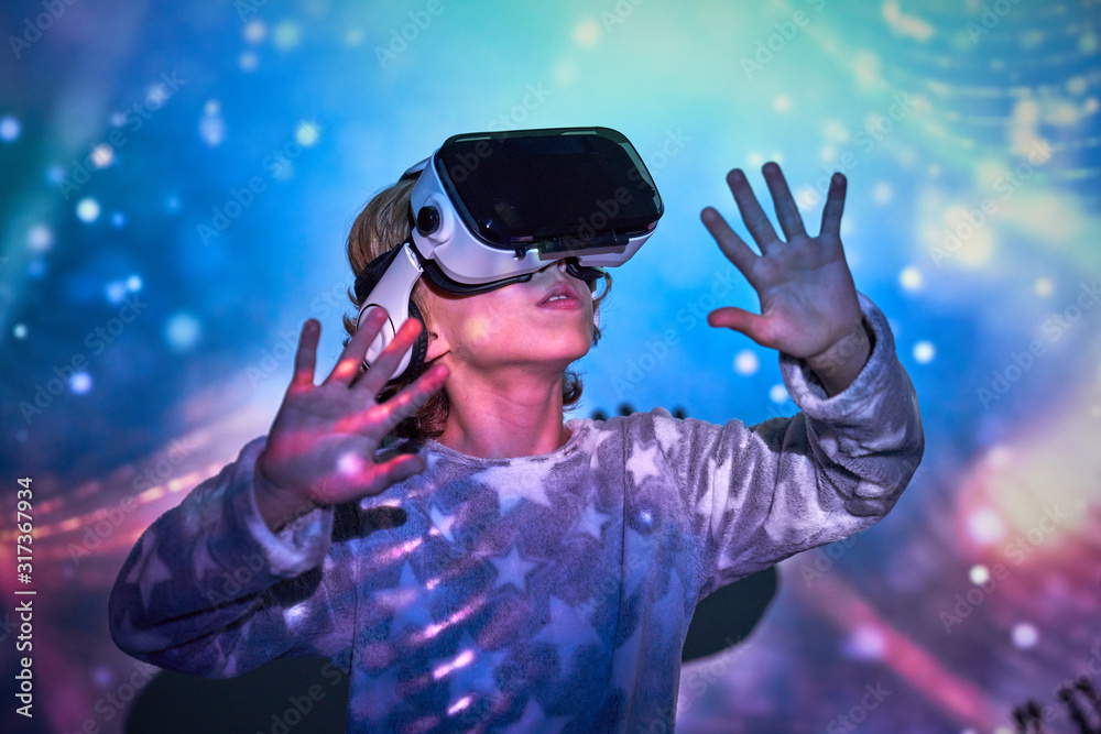 Child wearing virtual glasses at home with colored light effects Child wearing virtual glasses at home with colored light effects