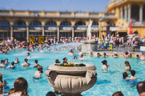 Budapest Spa Szechenyi Thermal Bath spa swimming pool with blue sky in summer day with a crowd of people photo