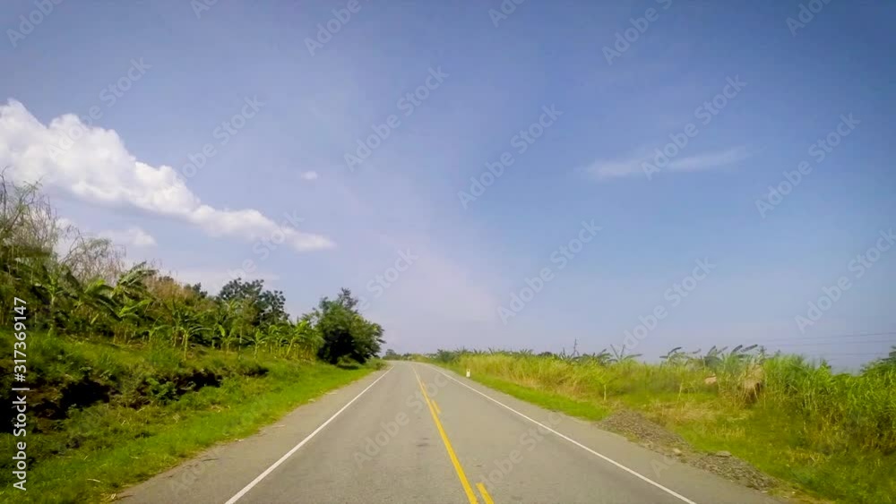 Time Lapse, car's front top view. road passing rural areas.