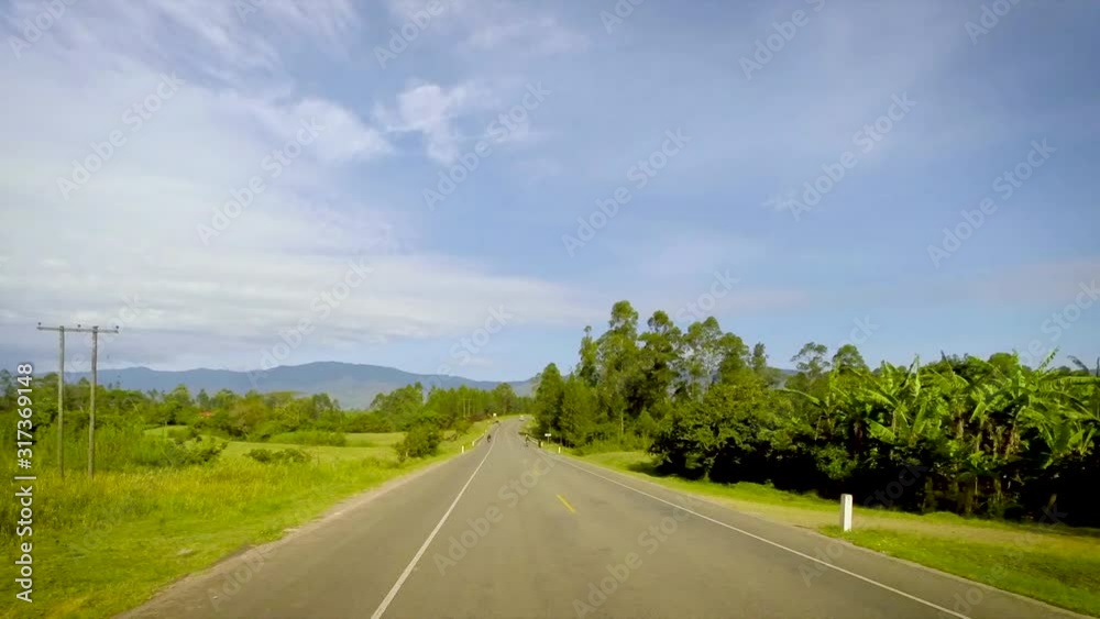 Time-Lapse View from car's top of green valley and the Rwenzori Mountains range in distance. Western Uganda. Time-Lapse View from car's top of green valley and the Rwenzori Mountains range in distance. Western Uganda.