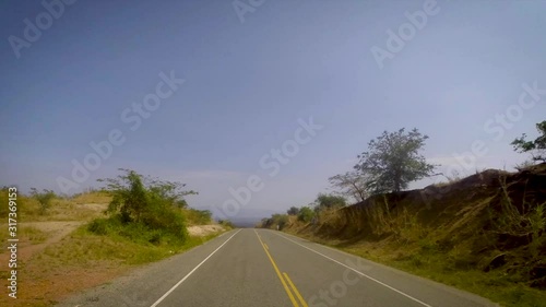 time lapse front view from car's top of the vast Karamoja land passing through Semliki Valley photo