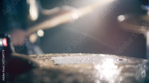 Surface of a wet drum cymbal while being played in a close up
