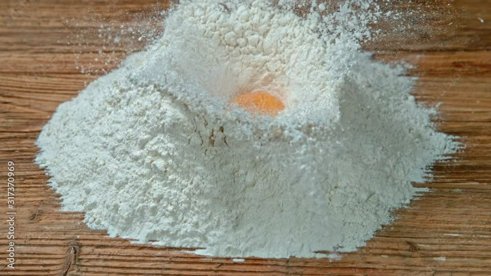 Super Slow Motion Shot of Falling Egg into Flour at 1000fps. Super Slow Motion Shot of Falling Egg into Flour at 1000fps.