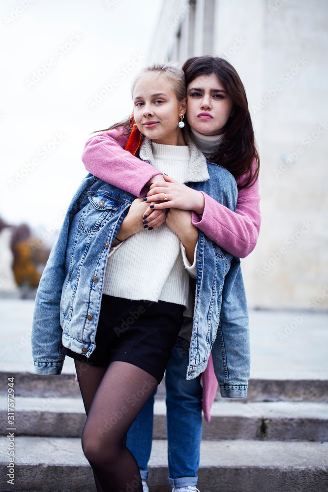 young happy students teenagers at university building on stairs, lifestyle people concept brunette and blond girl