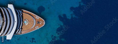 Aerial drone ultra wide photo of cruise liner nose cruising in Mediterranean Aegean deep blue sea photo