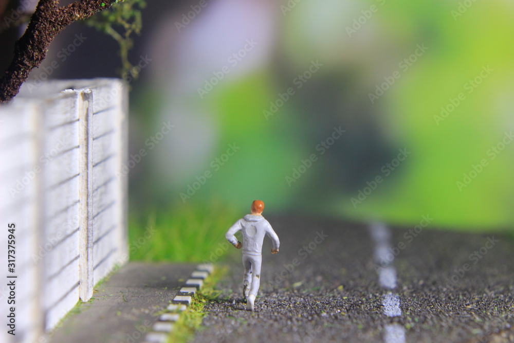 Obraz premium Illustration Photo, Cheap and Easy Sport in the morning, Alone Mini Figure Sport Man Toy at Asphalt Road