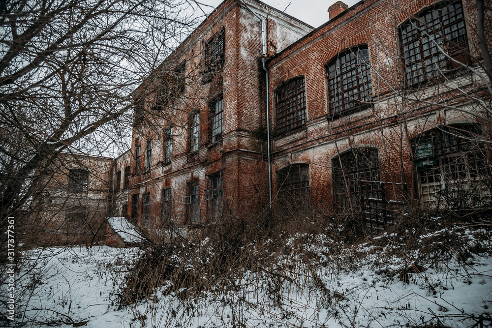 Dark and creepy abandoned haunted mental hospital in winter
