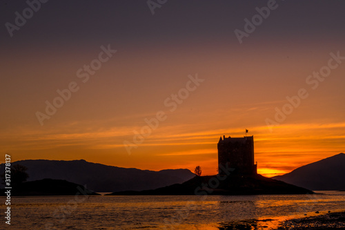 Castle stalker in silhouette with a dramatic sunset Scotland 