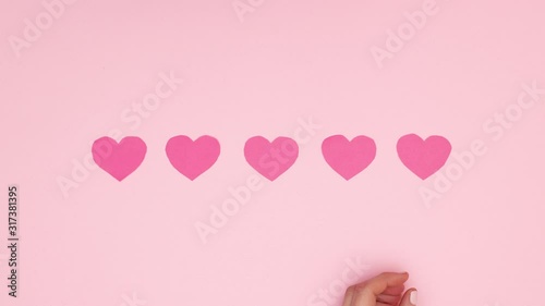 Wallpaper Mural Woman hand put five pink heart for Valentine's day - Stop motion  Torontodigital.ca