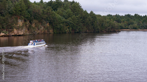 Cruising the scenic river, boat tour. Landscape, summertime,  cloudy day. Wisconsin river, Wisconsin Dells. photo