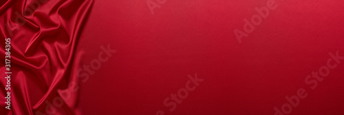 Abstract background from red silk or satin. Luxury fabric texture with draped. Copy space. Element design. Valentine's day.