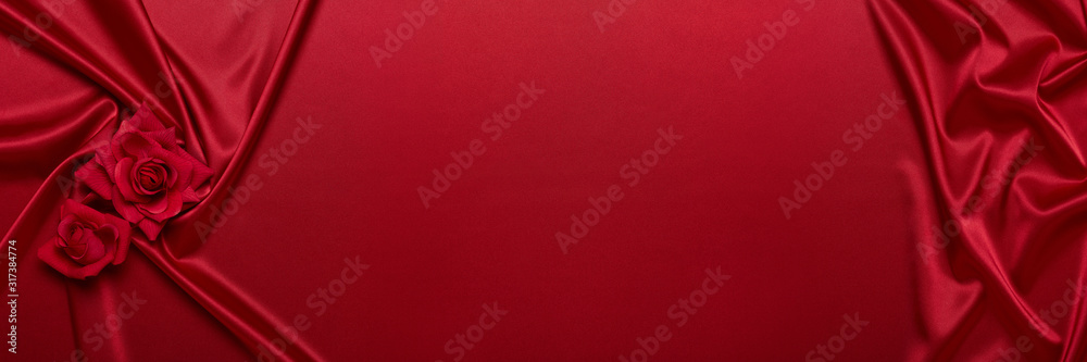 Abstract background from red silk (satin) and roses. Fabric texture with draped. Copy space. Element design. Valentine's day. Abstract background from red silk (satin) and roses. Fabric texture with draped. Copy space. Element design. Valentine's day.