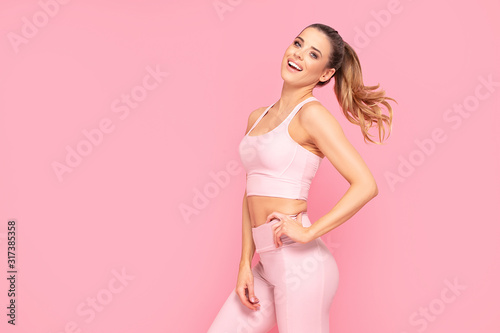 Vászonkép Smiling girl enjoying fitness training.