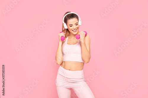 Fototapeta Naklejka Na Ścianę i Meble -  Smiling girl enjoying fitness training.