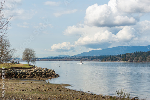 View over inlet  ocean and island with boat and mountains in beautiful British Columbia. Canada.