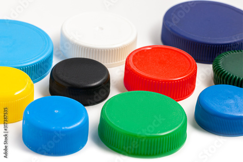 Colored plastic caps from bottles of water isolated on a white background.