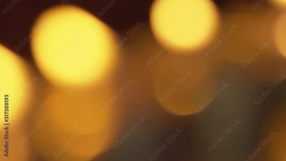 Defocused bokeh from candle flames glowing and shimmering in the gentle breeze Defocused bokeh from candle flames glowing and shimmering in the gentle breeze