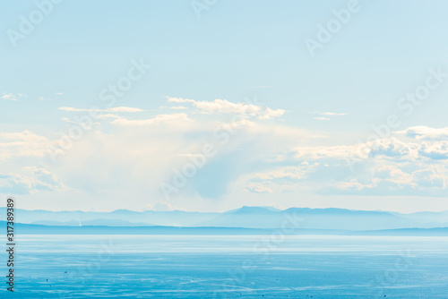View over inlet  ocean and island with boat and mountains in beautiful British Columbia. Canada.