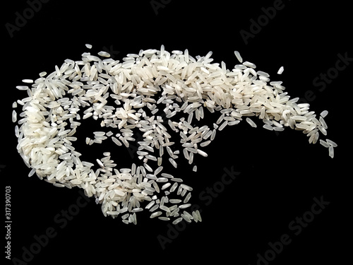 Abstract rice cloud and white rice explosion isolated on black background. pile rice isolated on black background.