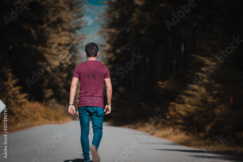 man walking on country road © Diego