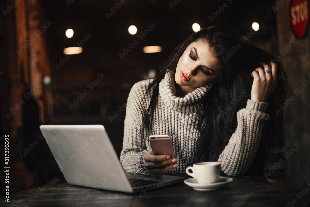 Business woman working on a laptop and drinking coffee in a cafe. Business woman working on a laptop and drinking coffee in a cafe.