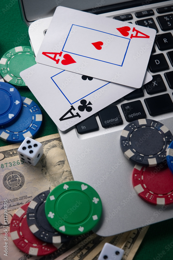 Fototapeta premium Gaming business. Internet betting services. Gambling on the site and winning money. Play poker online. Vertical frame.