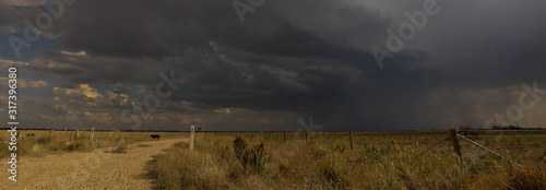 Obraz na plátne Panoramic image of Storm brewing over country back road and farmland near Pyrami