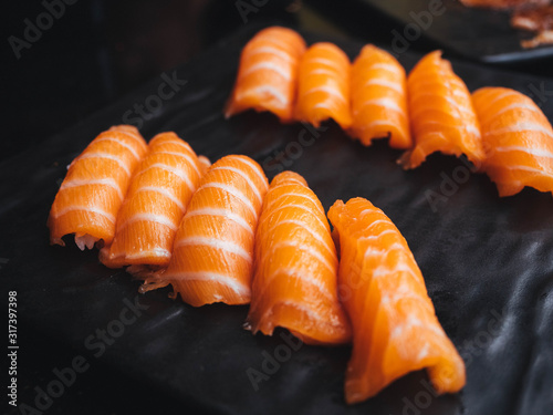 Salmon sushi over black background,close up
