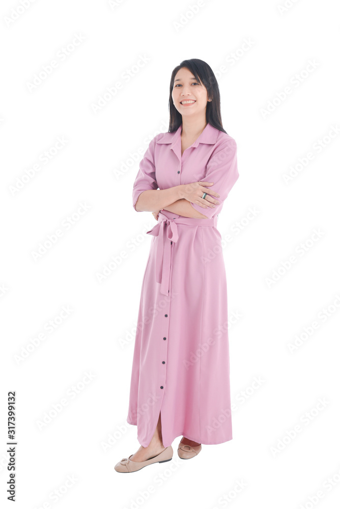 Full length of beautiful asian woman in pink dress doing crossed arm and smiling over white background.