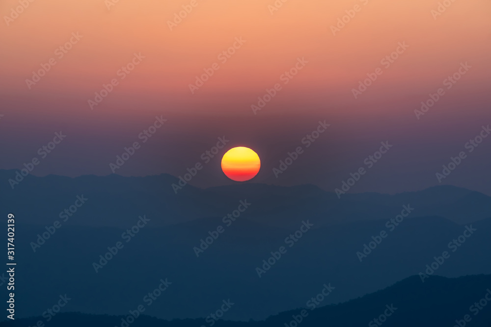 Close up beautiful sunrise over the mountains at Doi Samer Dao, Nan, Thailand.