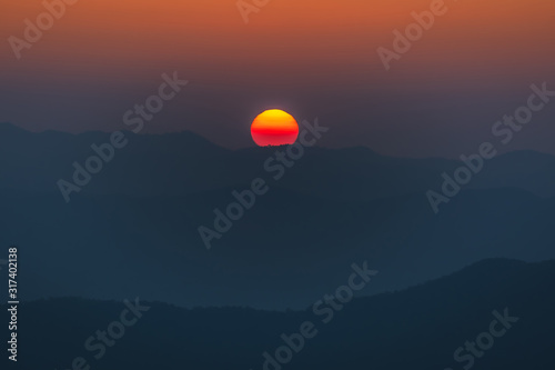 Close up beautiful sunrise over the mountains at Doi Samer Dao, Nan, Thailand.
