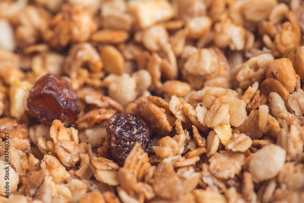 Useful and tasty muesli with nuts, rasins and flakes. Selective focus macro shot with very shallow depth of field. Healthy and vegetarian lifestyle Useful and tasty muesli with nuts, rasins and flakes. Selective focus macro shot with very shallow depth of field. Healthy and vegetarian lifestyle