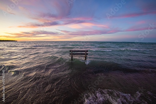Bench in sunset lake