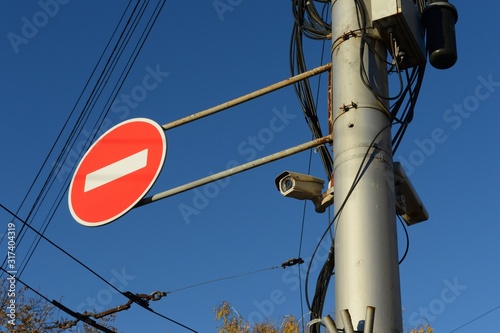 A video camera captures car violators of a prohibition sign on a city street photo