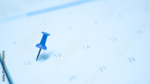 Close up  blue pin marking on calendar planning concept.