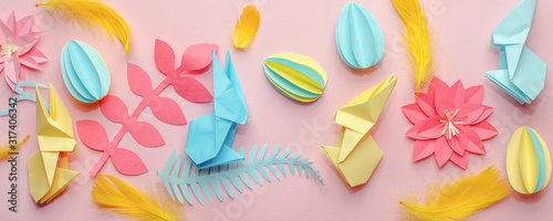 Easter holiday creative background with papercraft eggs, flowers, origami bunny on coral pink background, trendy paper craft holiday springtime background, banner, diy idea