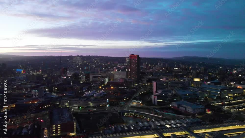 Sheffield City Centre drone shot over the sky line sheffield hallam bramall lane tall sky scraper aerial shot during sunset night shot sun down blue orange purple sky UK city