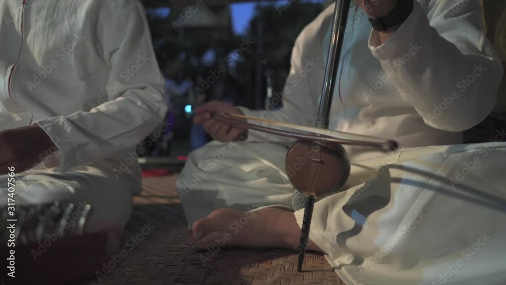 Man playing on on Chinese Hammered Dulcimer Man playing on on Chinese Hammered Dulcimer