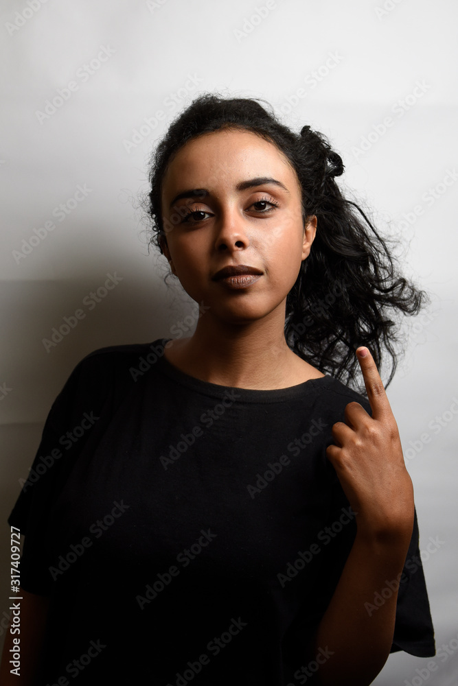 middle eastern girl over white background showing and lifting a finger in sign of the best middle eastern girl over white background showing and lifting a finger in sign of the best