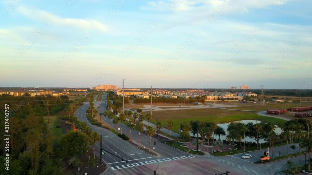Aerial Drone View Rising Up of Cars Passing on Universal Blvd in Orlando Florida near Orlando Convention Center in Tourism District During Sunset on a Partly Cloudy Afternoon Day Aerial Drone View Rising Up of Cars Passing on Universal Blvd in Orlando Florida near Orlando Convention Center in Tourism District During Sunset on a Partly Cloudy Afternoon Day