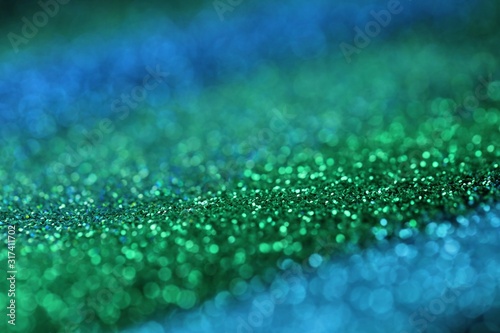 glitter background.blue and Green shiny gloss layout. Green and blue striped glitter with shining bokeh.Vibrant background with twinkle lights. glitter brilliant mockup