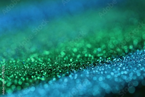 glitter background.blue and Green shiny gloss layout. Green and blue striped glitter with shining bokeh.Vibrant background glitter brilliant mockup