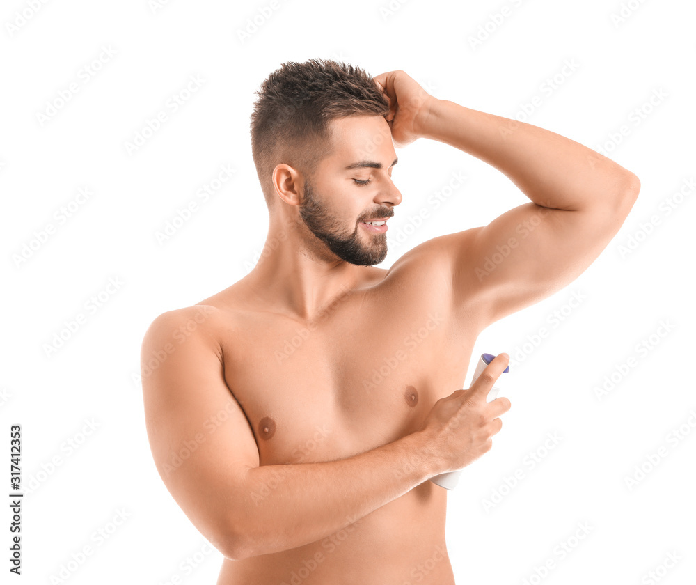 Handsome young man using deodorant on white background Handsome young man using deodorant on white background
