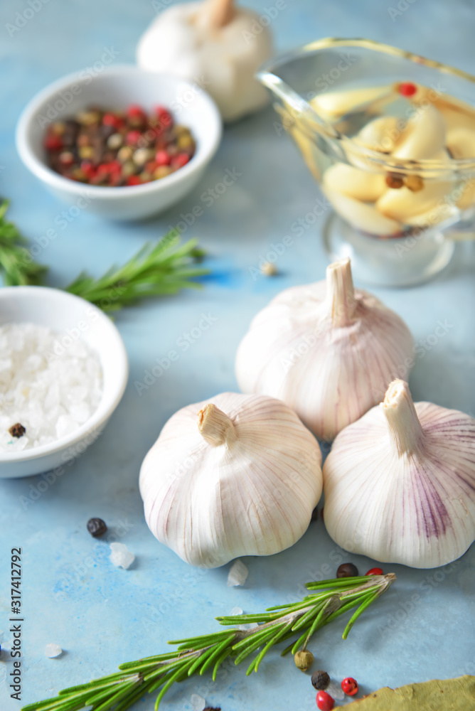 Fresh garlic with spices and herbs on color background Fresh garlic with spices and herbs on color background